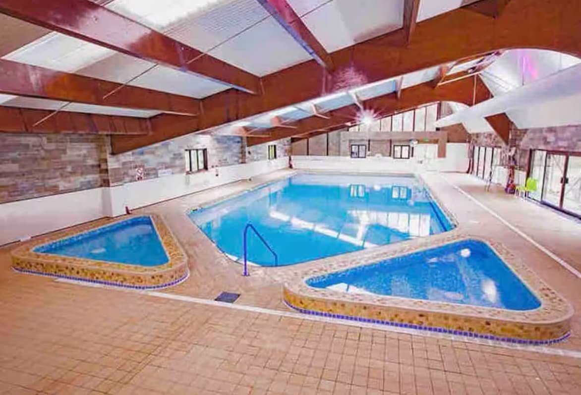 Shared heated indoor swimming pool with main pool and children's paddling pool