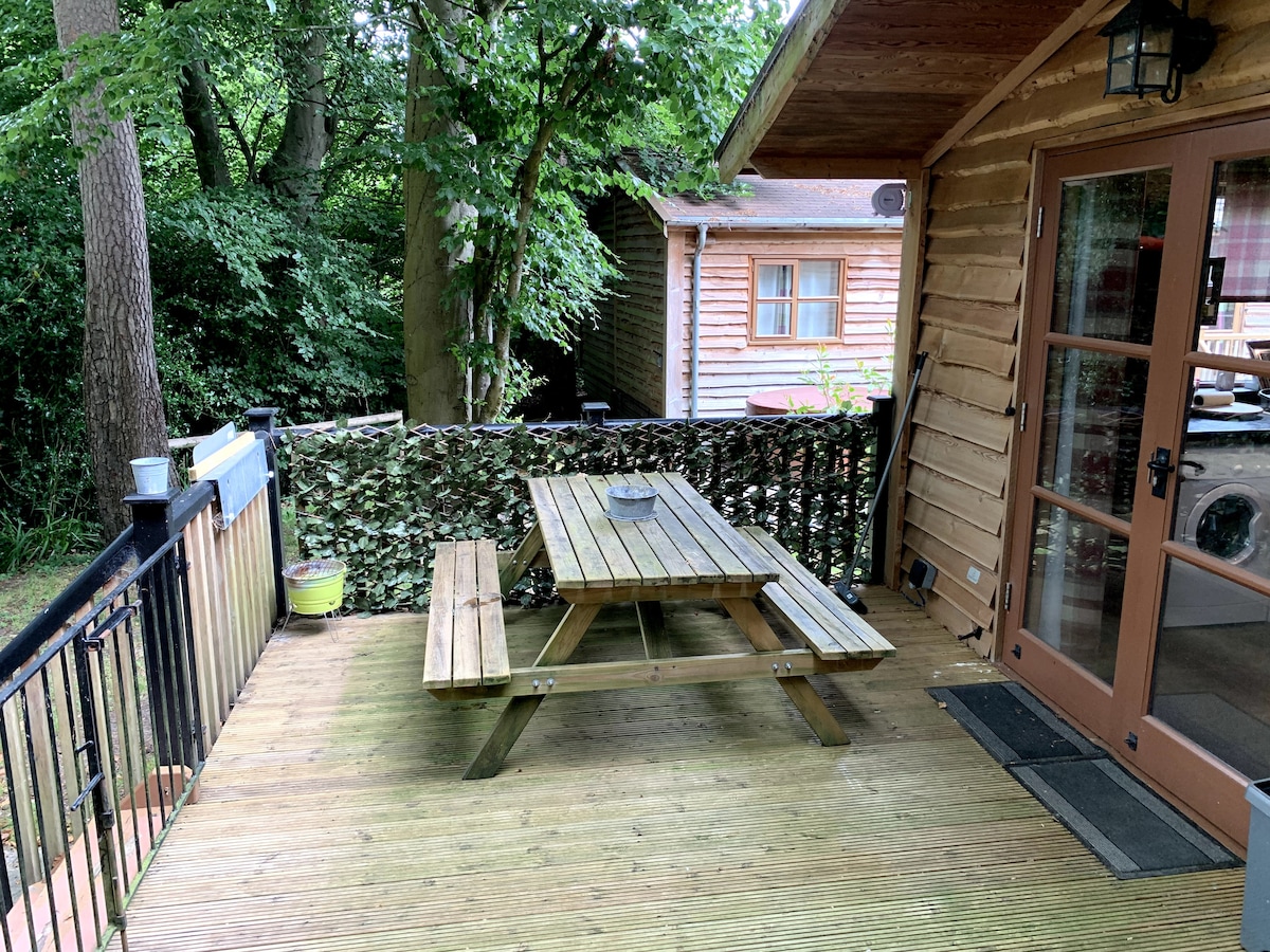 Deck with picnic table and French doors opening into the cabin
