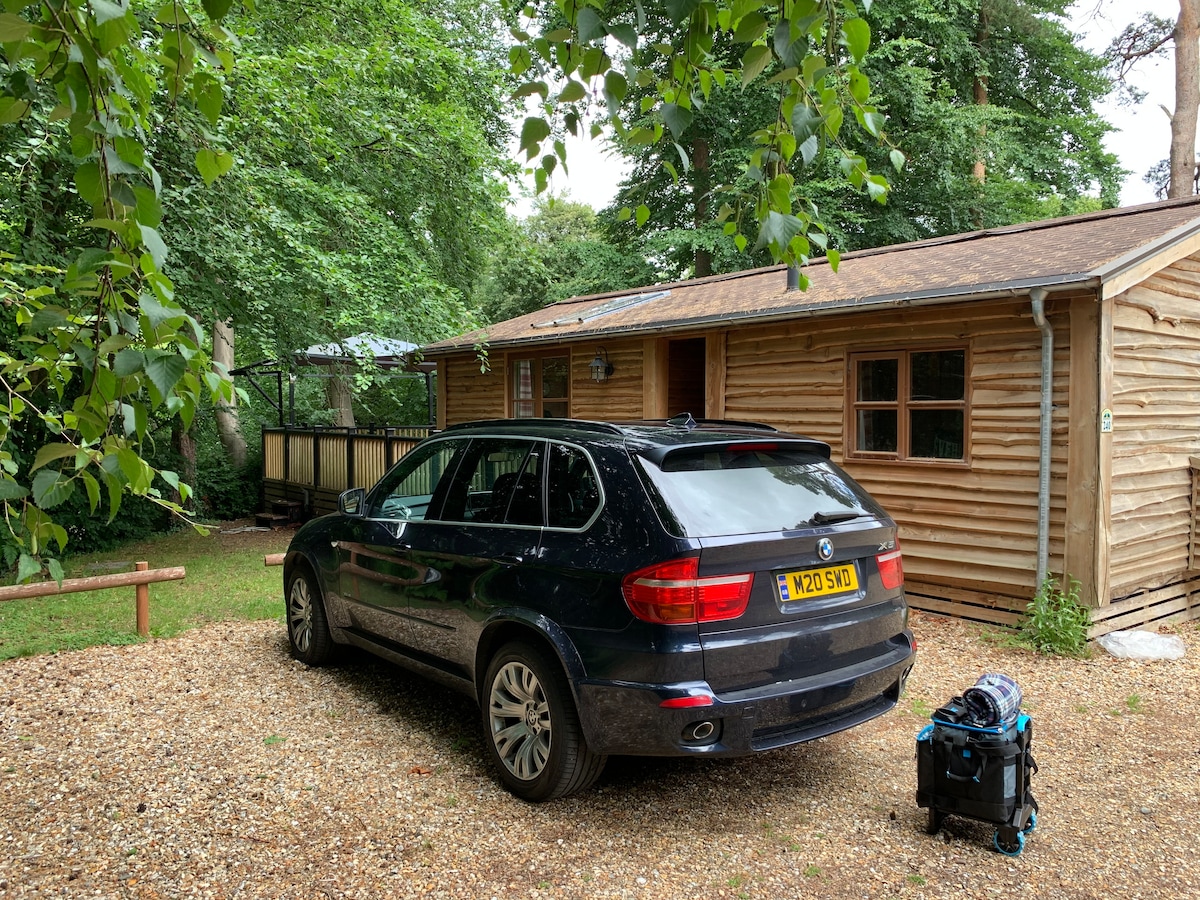 Log cabin exterior with private gravel parking
